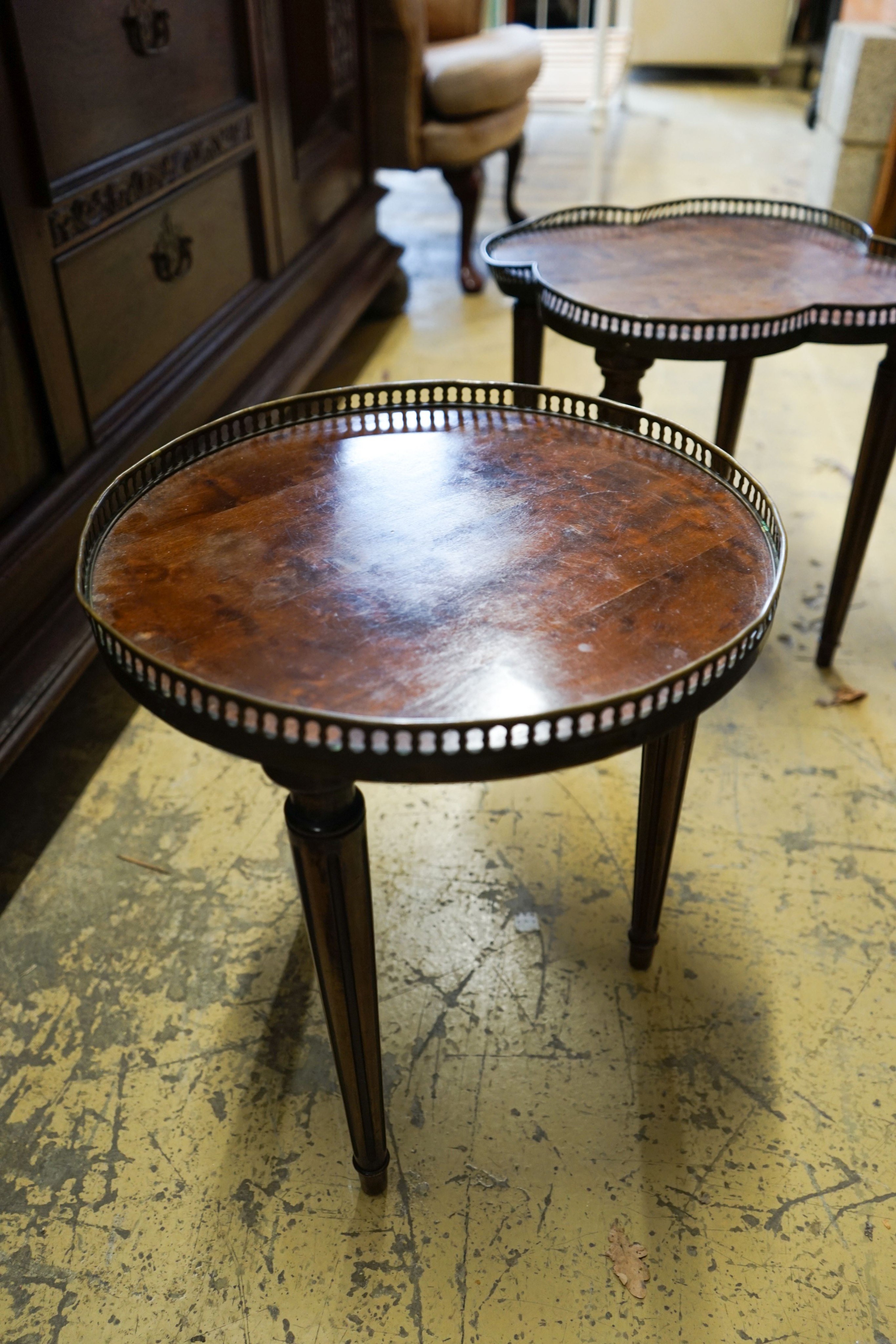 A circular burr walnut cabriole leg coffee table, diameter 84cm, height 47cm together with two Continental mahogany side tables with fretted brass galleries